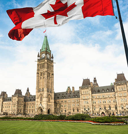 Government Building on Parliament Hill in Ottawa with canada flag